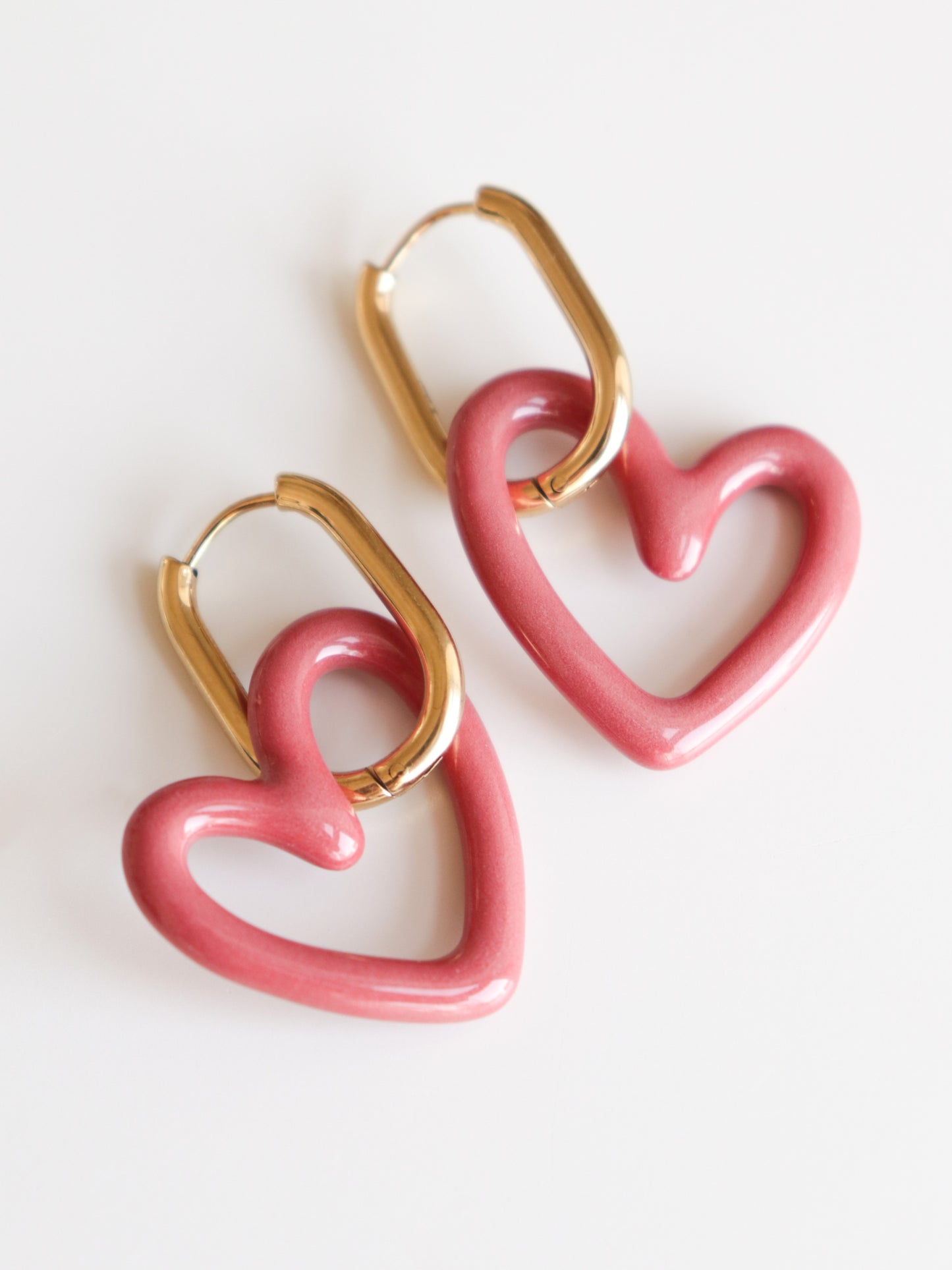 Heart Earrings by Rozenthal Jewelry—gold hoops with pink heart-shaped charms—lightweight, waterproof design shown on a white background.