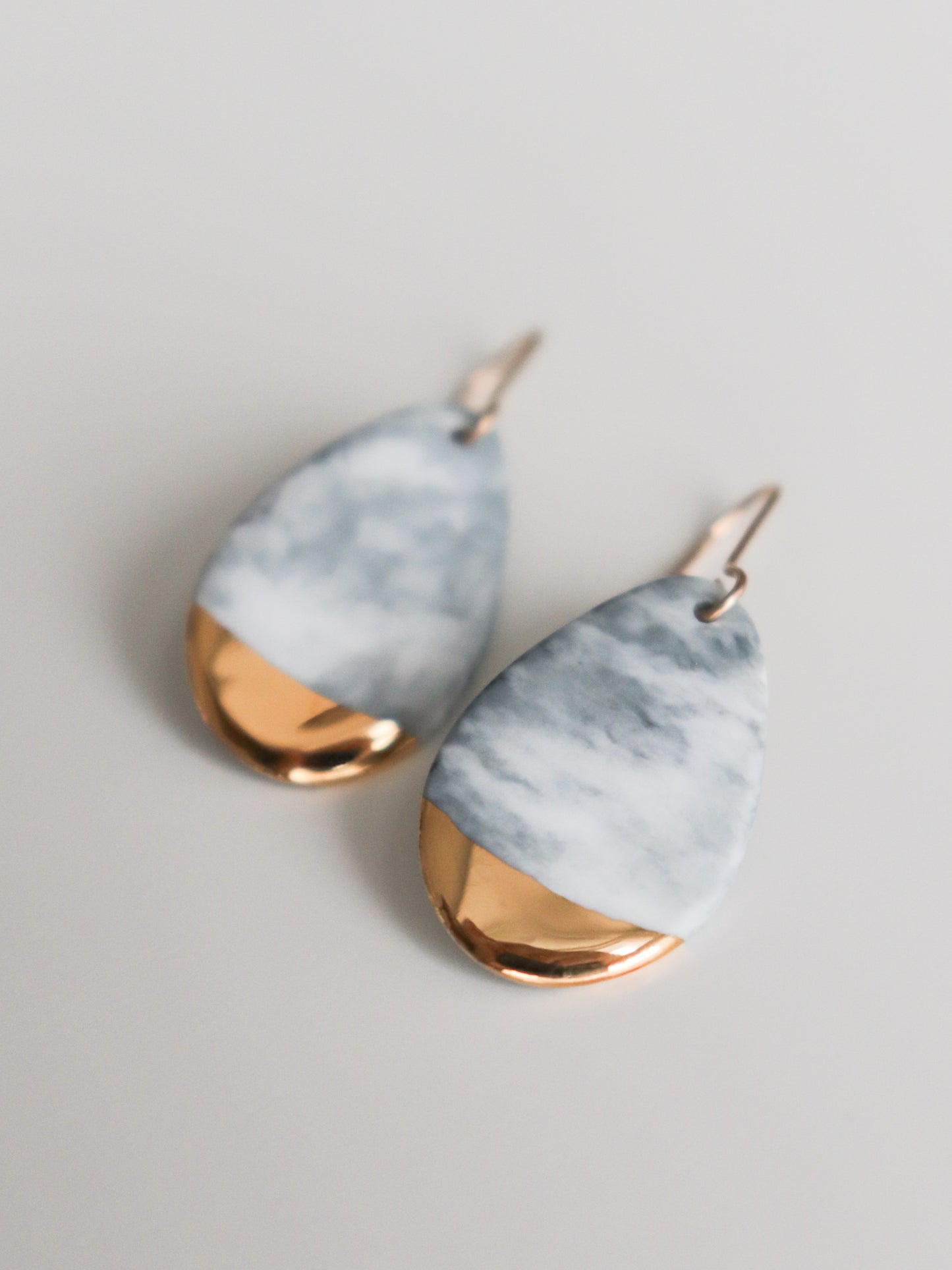 Rozenthal Jewelrys Drop Earrings / S are handmade teardrop-shaped earrings with a marbled gray and white upper and shiny gold accents—an elegant, sustainable addition to any jewelry collection.