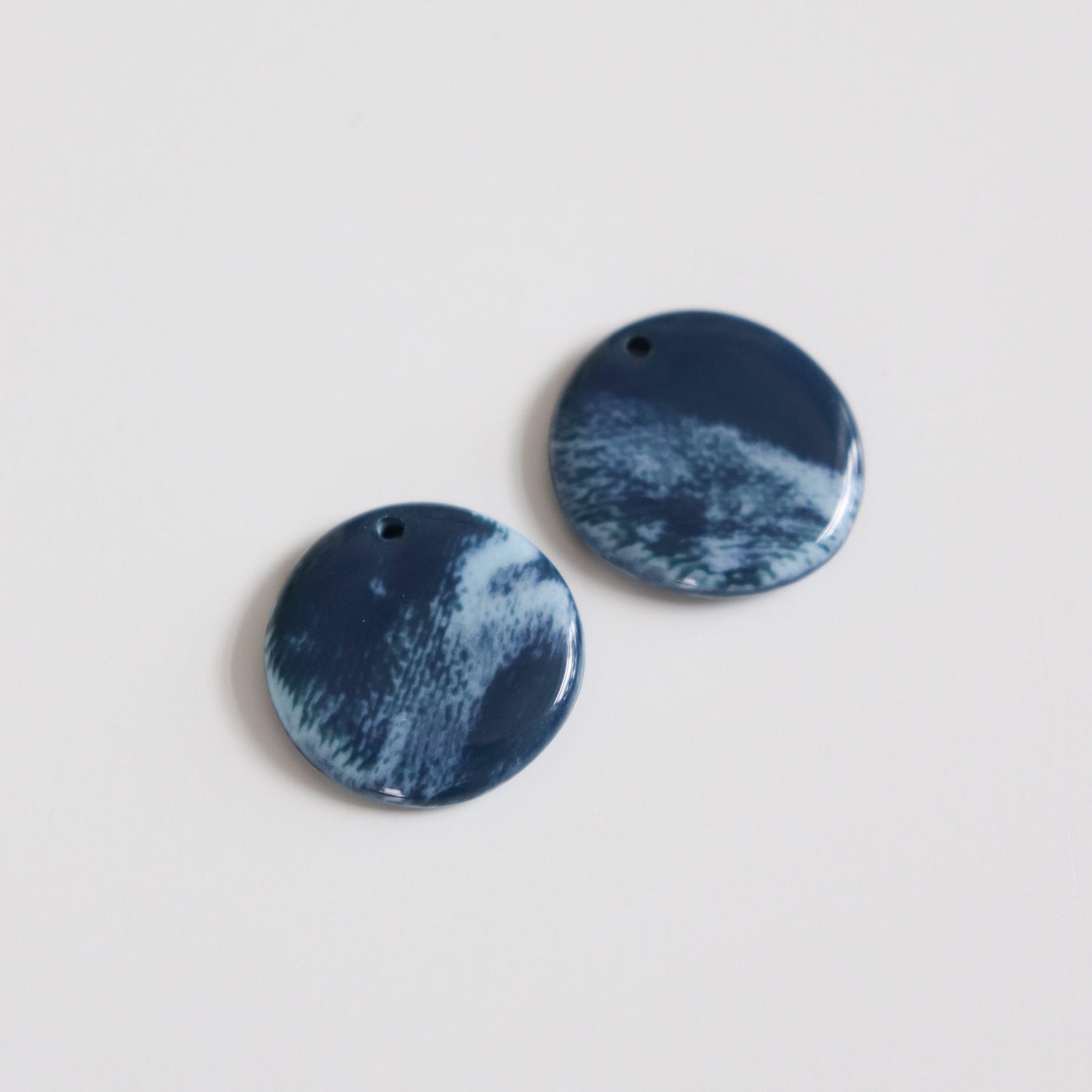 The Marée Earrings by Rozenthal Jewelry are handmade blue and white round porcelain statement earrings, each piece crafted for a unique touch.