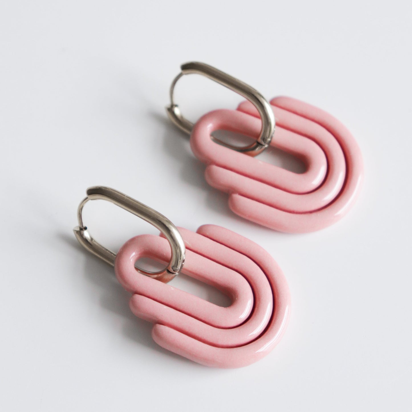 Art Deco Earrings by Rozenthal Jewelry—modern pink, layered geometric shapes with silver clasps, handmade in Latvia and shown on a white background.