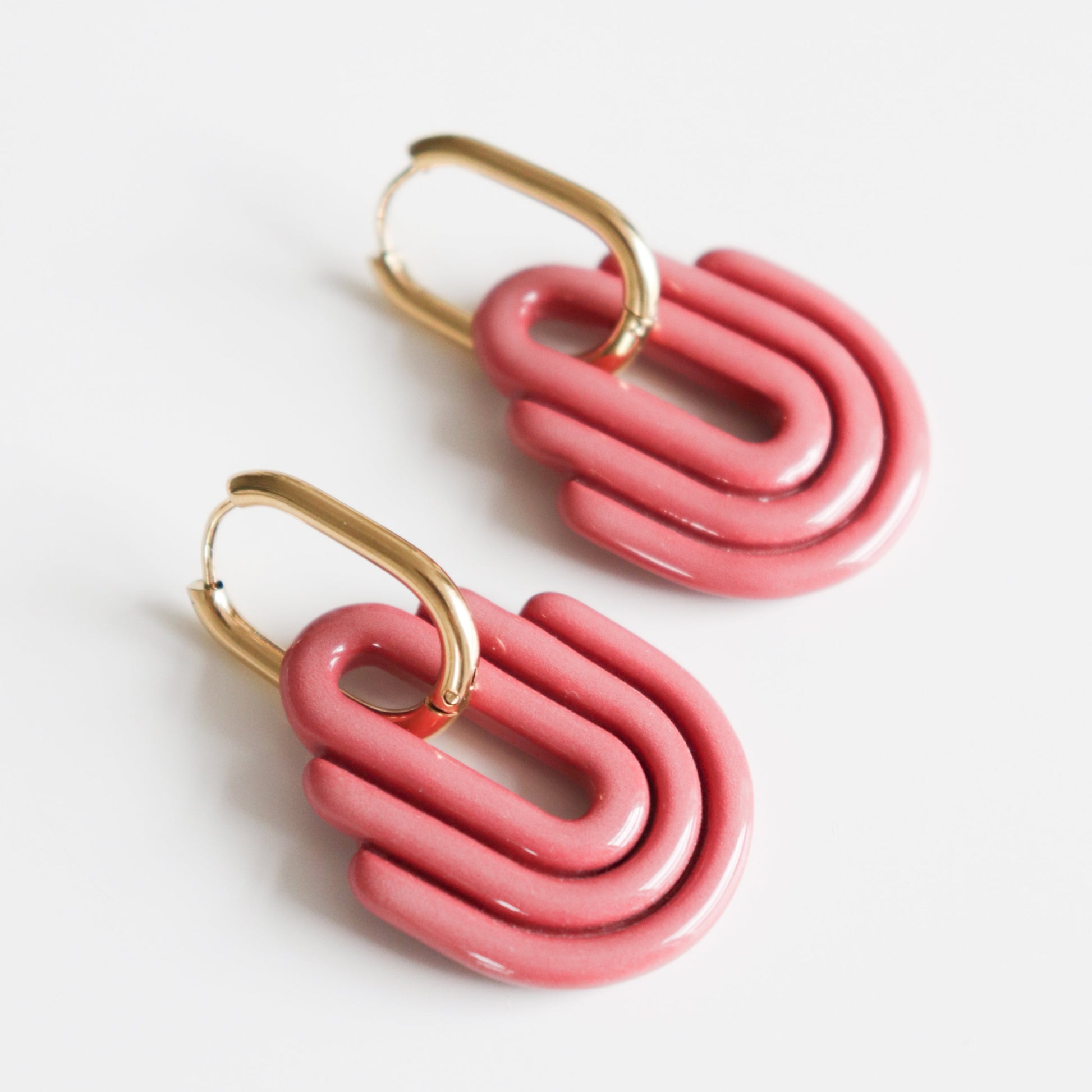 Art Deco Earrings by Rozenthal Jewelry—modern handmade earrings with gold hooks and bold pink geometric arches. Crafted in Latvia for a unique touch, shown on a white background.