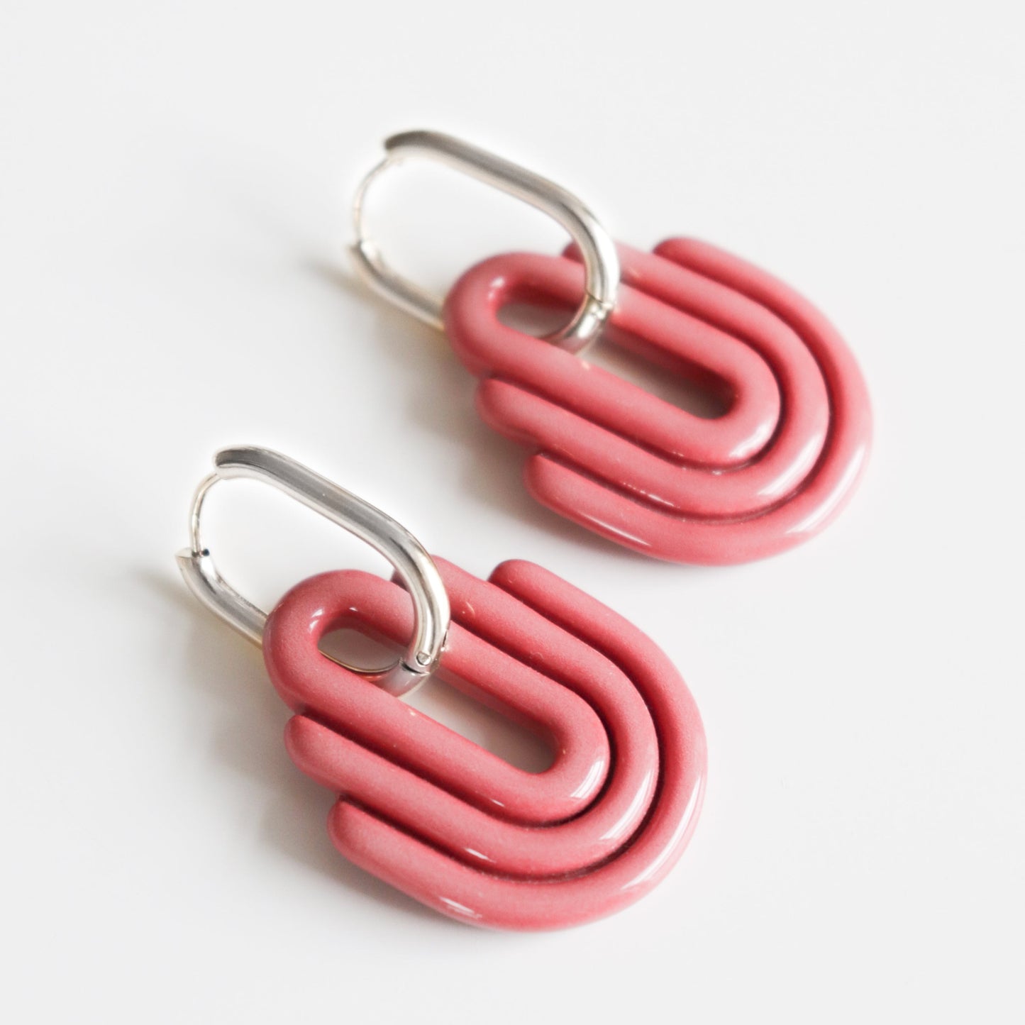 Art Deco Earrings by Rozenthal Jewelry—modern, handmade earrings with pink, curved, layered shapes and silver hooks, shown against a white background.