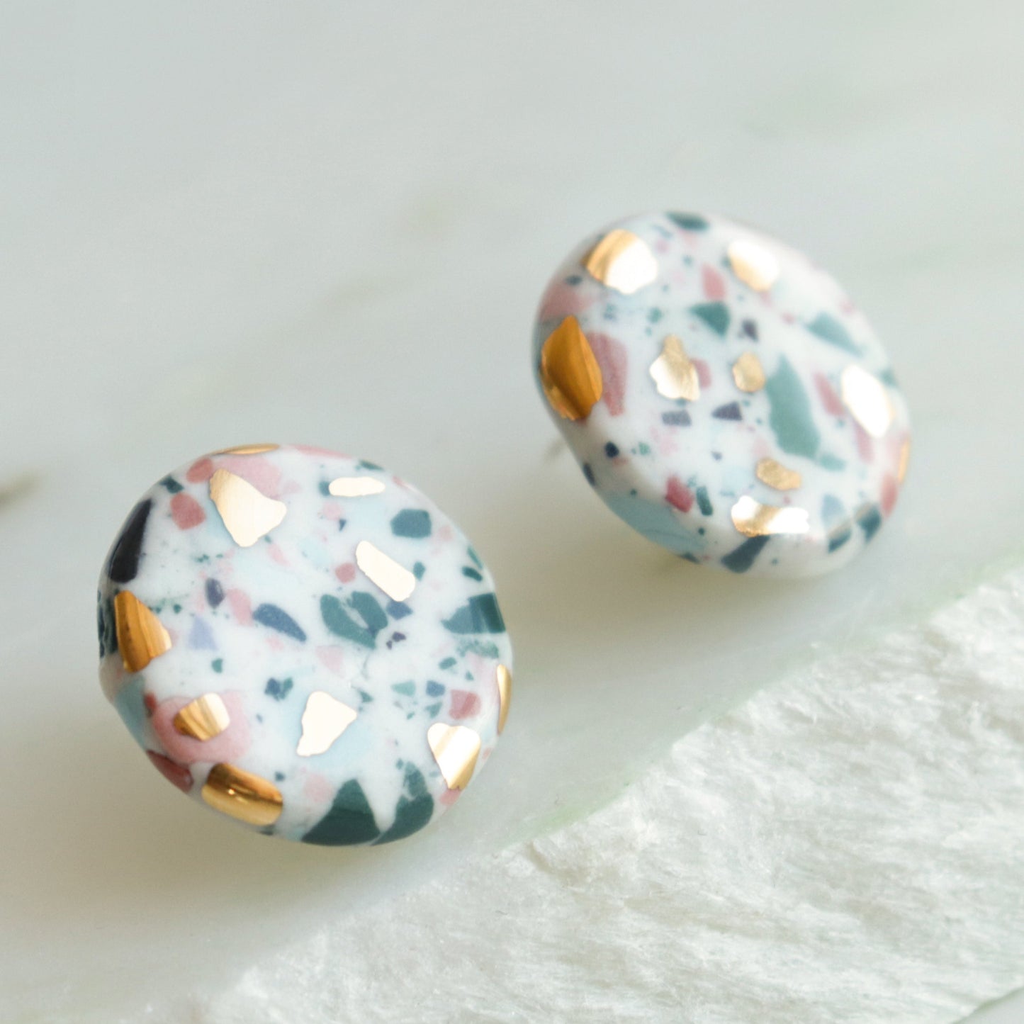 Astilla Recycled Studs / S by Rozenthal Jewelry are round terrazzo-pattern earrings with white, pink, green, and gold flecks—ideal for lovers of unique handmade jewelry.