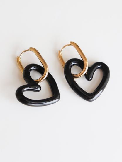 Heart Earrings by Rozenthal Jewelry: Handmade in Latvia, these gold hoops feature large black heart-shaped pendants, shown on a white background.