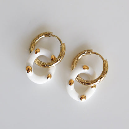 Pair of white round porcelain hoop earrings with gold drops