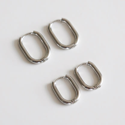 Set of four silver hoop earrings on a white background